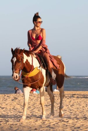 Alessandra Ambrosio - In a bikini horseback riding on the beach in Trancoso