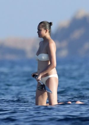 Chrissy Teigen - In White Bikini on holidays in Sardinia