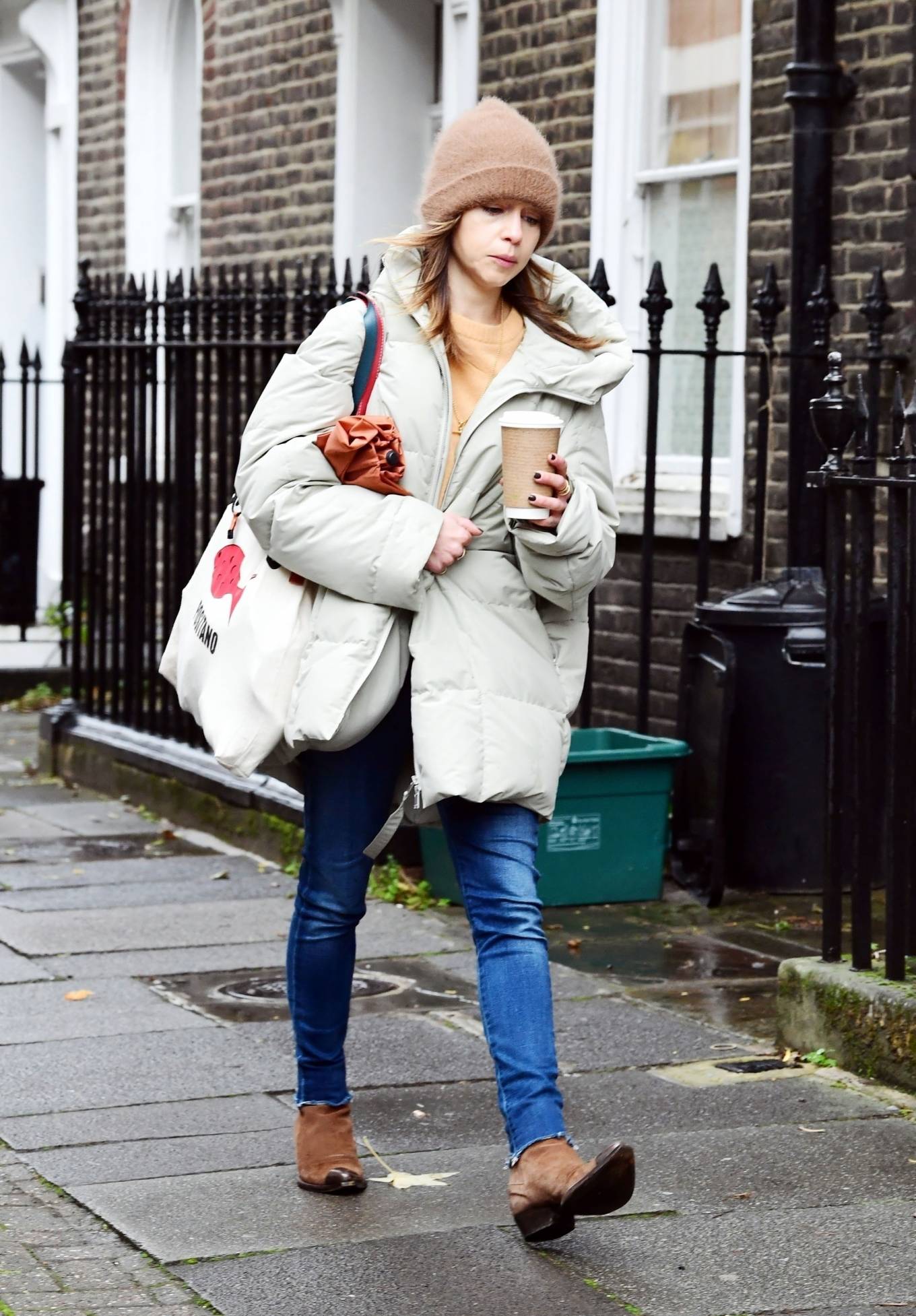 Emilia Clarke – In an oversized puffer jacket running errands in London