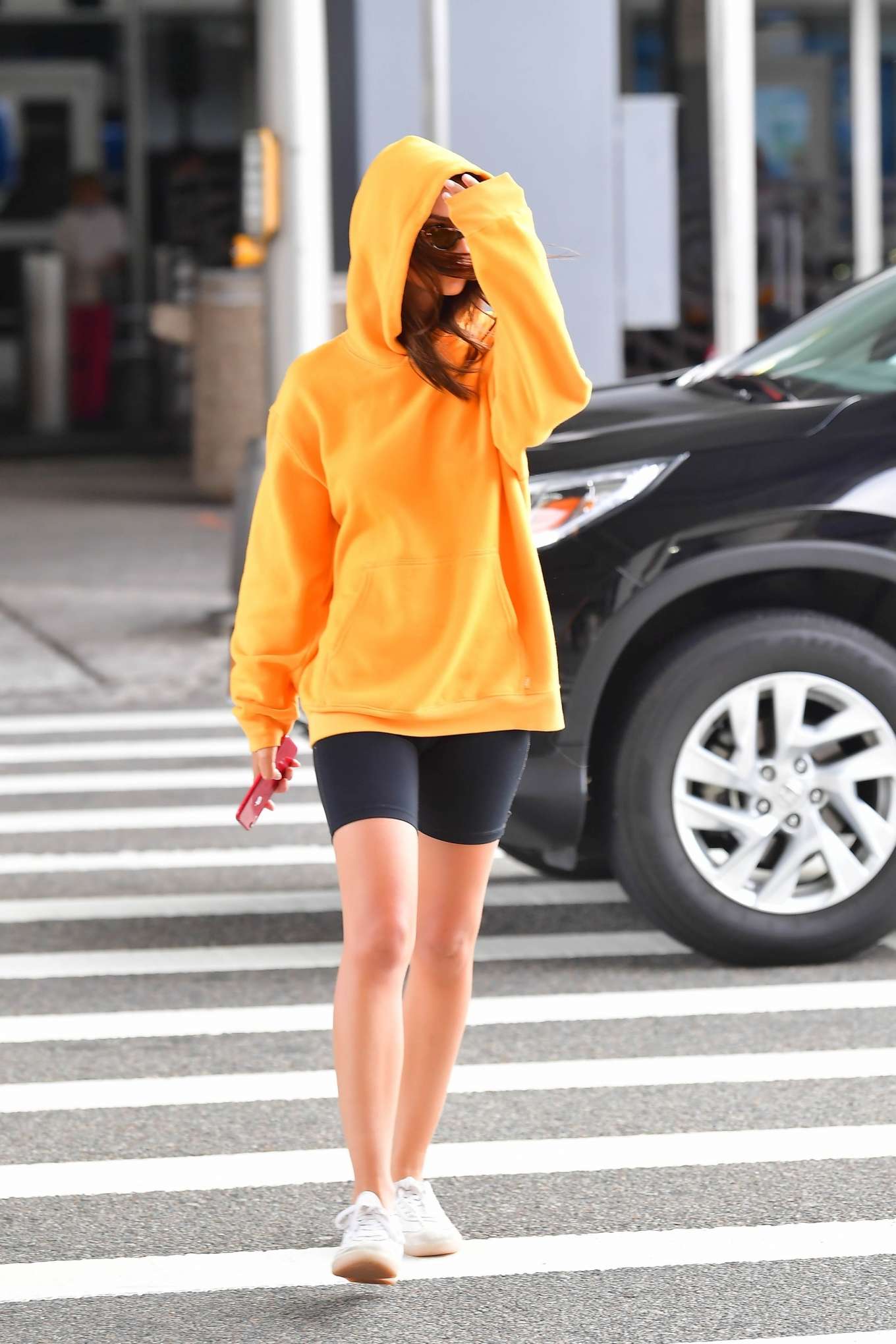 Emily Ratjakowski â€“ Wearing an orange hoody out in Brooklyn