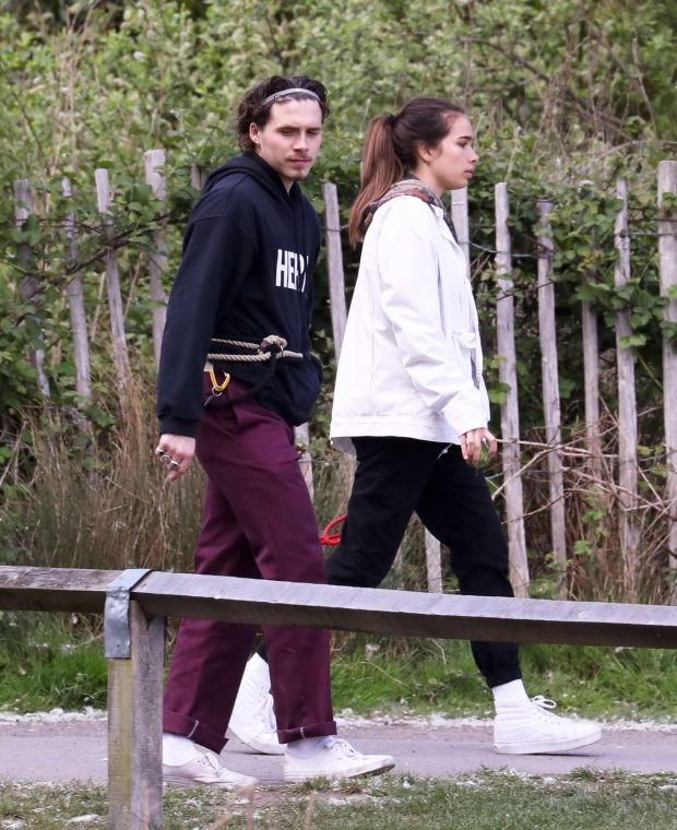 Hana Cross and Brooklyn Beckham take their dogs on a walk in London