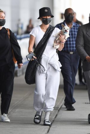 Kaley Cuoco - Arrives with her dog at JFK Airport in New York