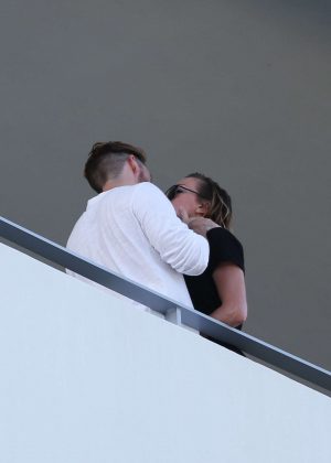 Katie Cassidy kissing her new boyfriend on the balcony in Miami