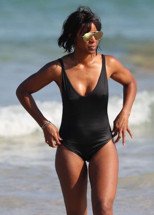 Kelly Rowland in Black Swimsuit on the beach in Sydney