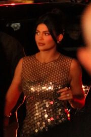 Kylie Jenner in gold dress as she arrives to Tom Ford Fashion show