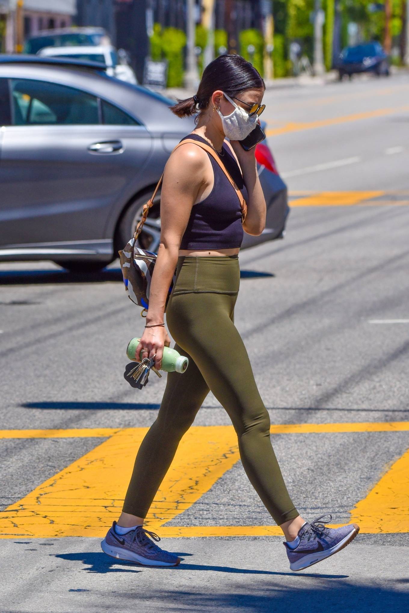 Lucy Hale in Green Tights at a gas station in Studio City